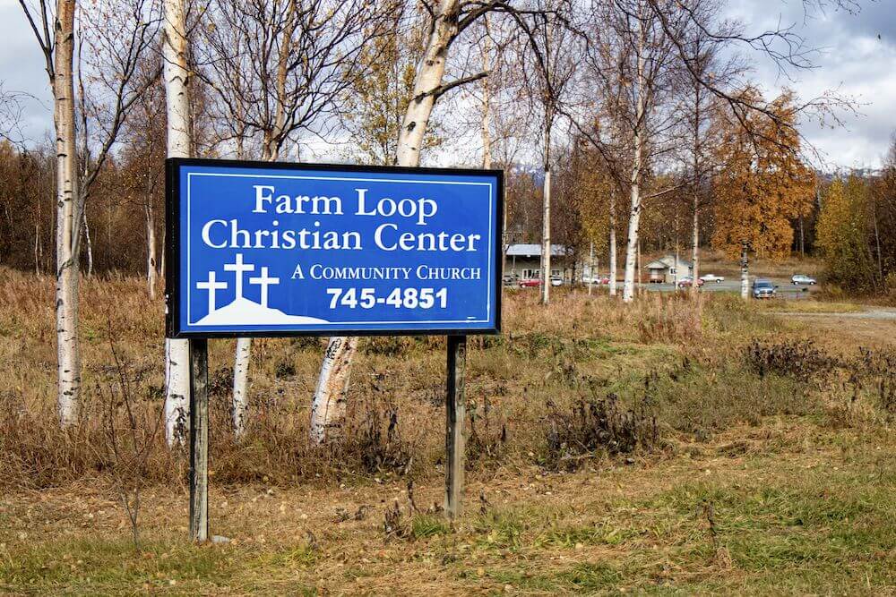 Blue sign: Farm Loop Christian Center A community church 745-4851
